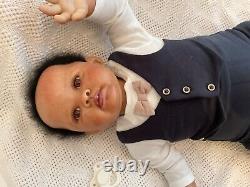 Stunning black reborn baby boy. 6 lbs. Black curly hand-rooted hair. 23 ins