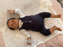 Stunning black reborn baby boy. 6 lbs. Black curly hand-rooted hair. 23 ins