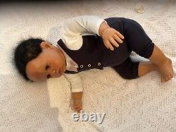 Stunning black reborn baby boy. 6 lbs. Black curly hand-rooted hair. 23 ins