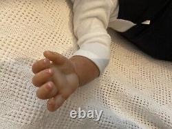 Stunning black reborn baby boy. 6 lbs. Black curly hand-rooted hair. 23 ins