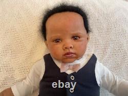 Stunning black reborn baby boy. 6 lbs. Black curly hand-rooted hair. 23 ins