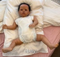 Stunning black reborn baby boy. 6 lbs. Black curly hand-rooted hair. 23 ins