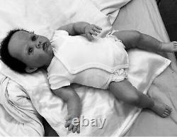 Stunning black reborn baby boy. 6 lbs. Black curly hand-rooted hair. 23 ins